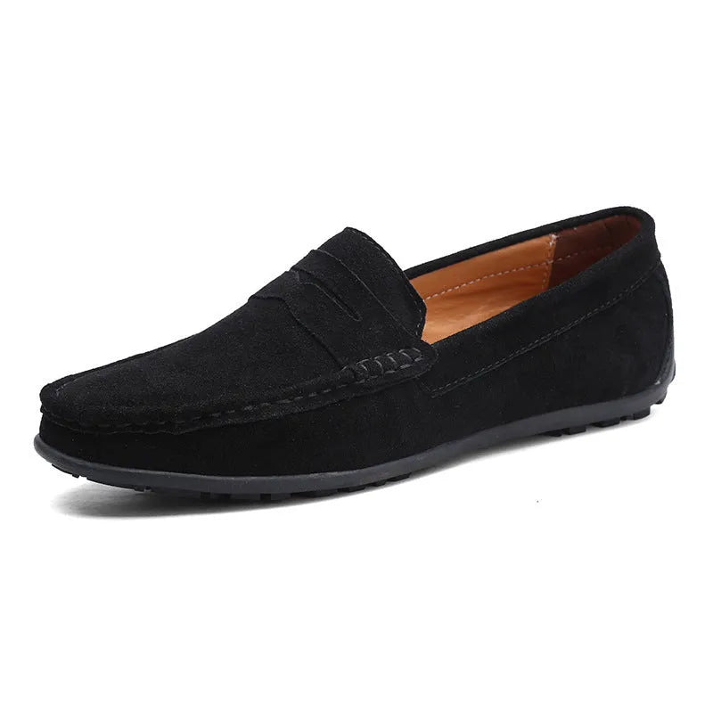 Men's brown suede casual loafers with a round toe, flat rubber sole, and visible stitching on a white background.