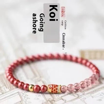Women's bracelet with purple cinnabar and pink strawberry quartz beads, koi design, on wrist.