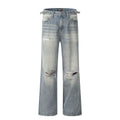 Man wearing blue retro-style straight-leg jeans with a ripped, distressed finish on the legs.