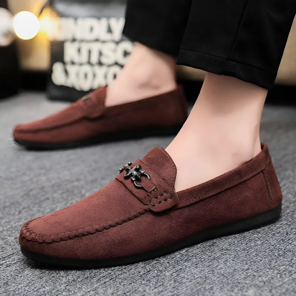 Men's black and brown waterproof slip-on loafers with round toe and low heel on a white background.