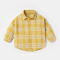 Boy wearing a long sleeve cotton casual shirt with a lattice animal print in light blue.