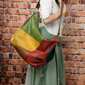 Brown cowhide leather crossbody travel bag showing front flap and adjustable shoulder strap.