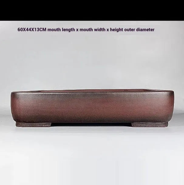 Handmade antique rectangular purple clay flower pot showing traditional ceramic texture