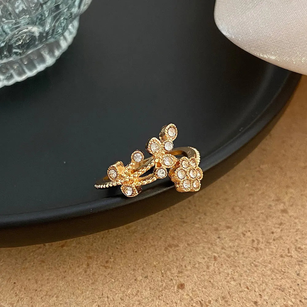 Open-mouth copper ring with diamond-cut flower and leaf design for women in gold or white finish