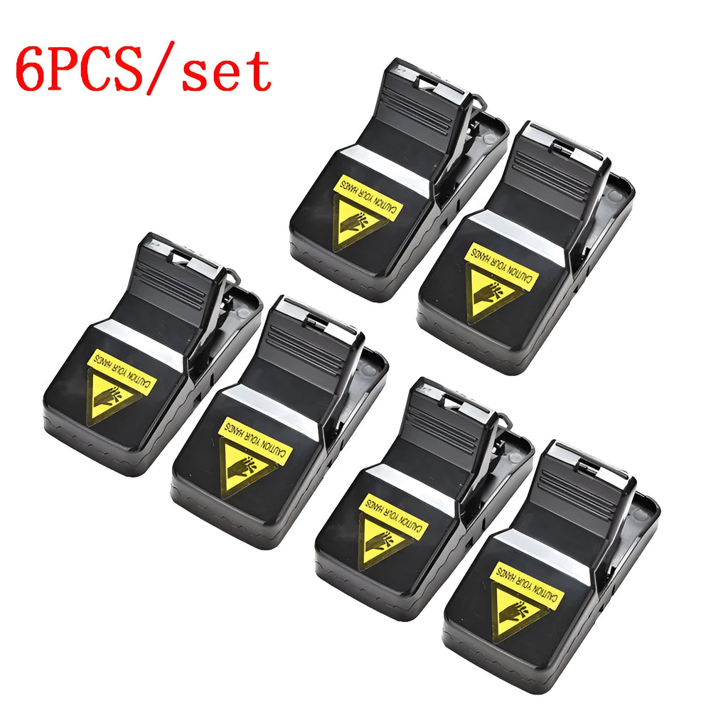 Six black plastic snapping mousetraps showing bite-trap mechanism with ruler showing 11cm length