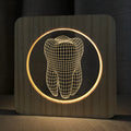 Tooth-shaped wooden colour acrylic USB night lamp on a table