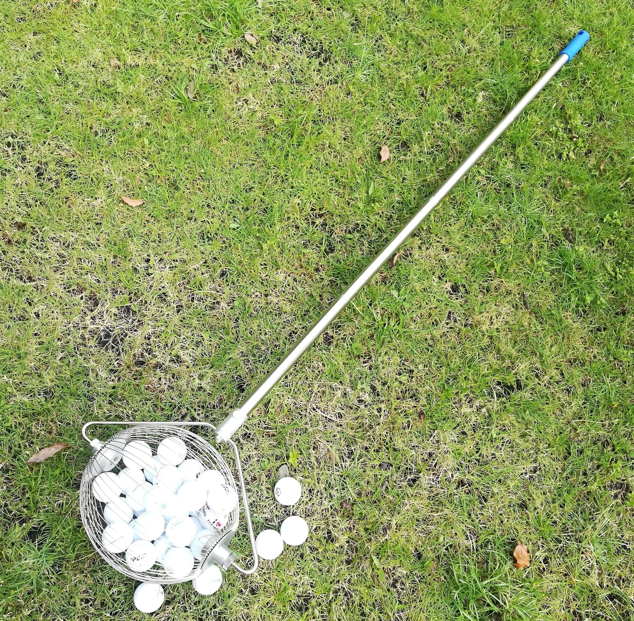 A metallic coloured 304 stainless steel golf ball picker on a green background.