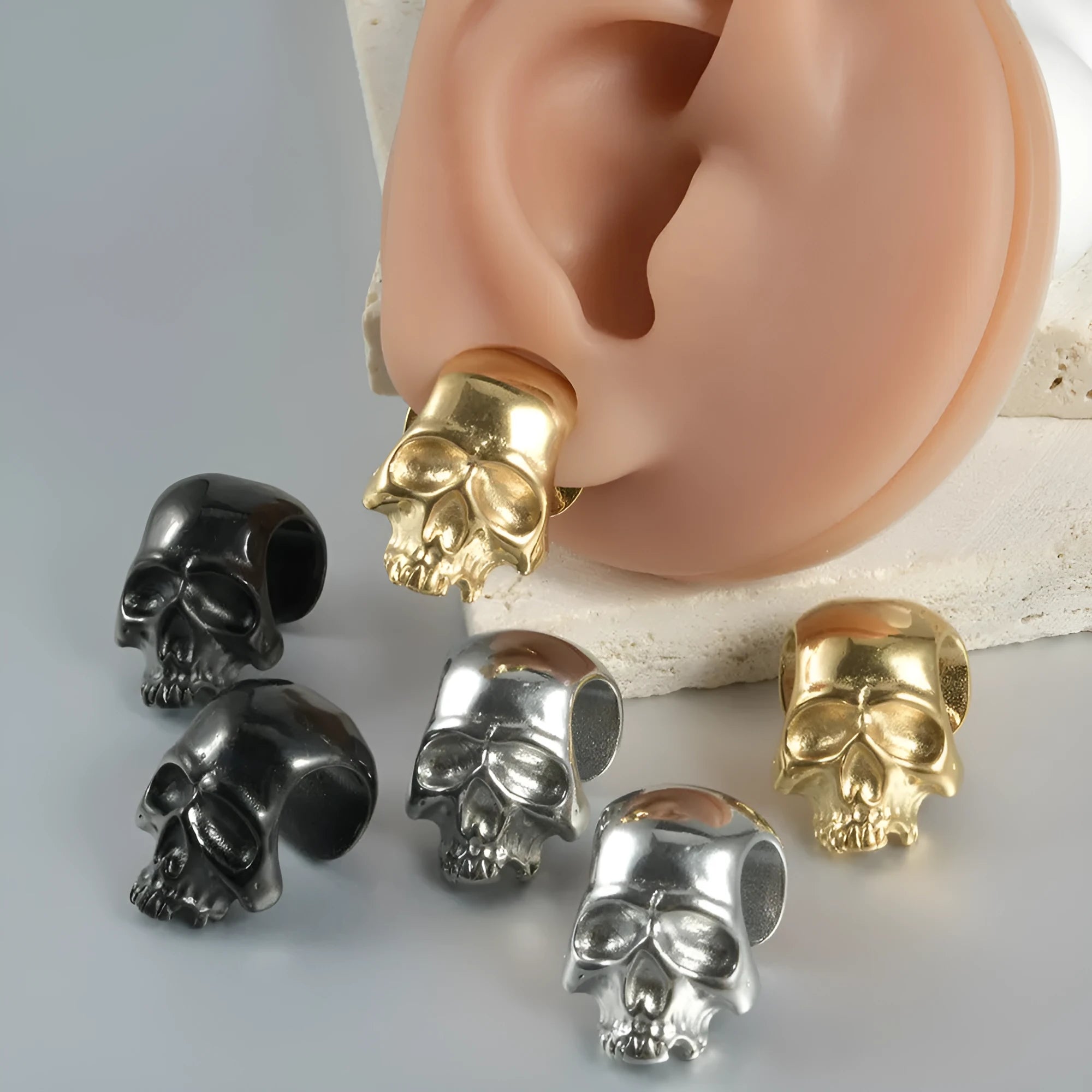 Stainless steel hollow skull Buddha earrings in four electroplated colour options