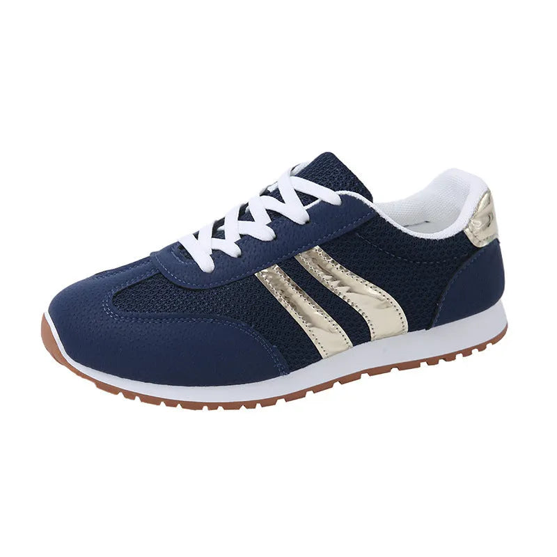 Blue women's casual tennis shoes with a cross strap and white non-slip rubber sole.