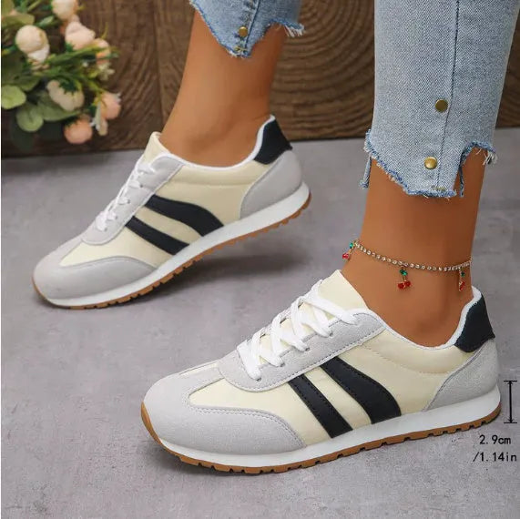 Blue and grey leisure sports shoes with Cortez stripes, flat rubber sole, and round toe.