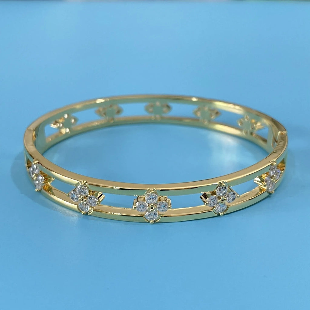 Gold and silver women's hollow bracelets with a four-leaf clover charm and zircon detailing.