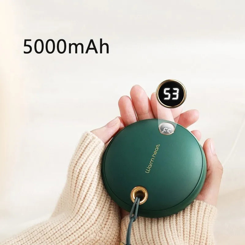 Green hand warmer power bank with digital display showing battery level, next to a charging cable.
