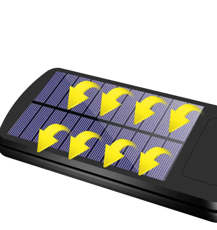 Black outdoor solar-powered motion sensor security light with solar panel on top.