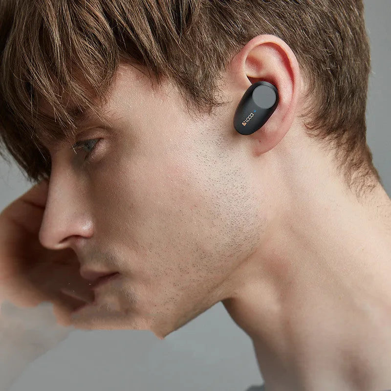 Black wireless Bluetooth headset with charging stand featuring active noise cancellation