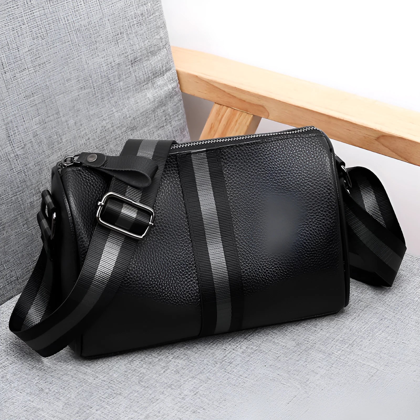 Black genuine leather one-shoulder crossbody bag showing front view and strap.