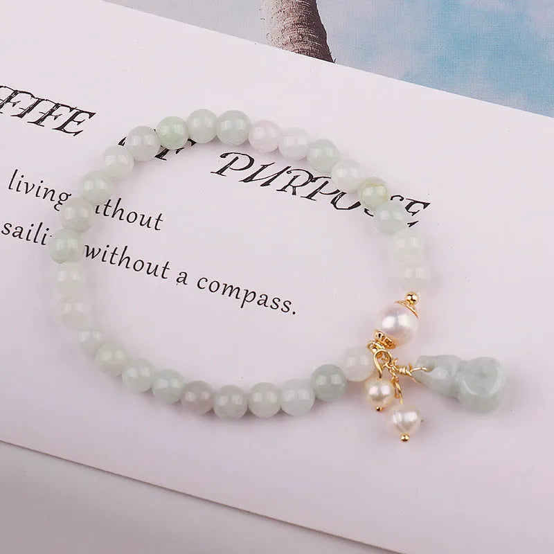 Chinese style women's jade bracelet with hand-carved emerald gourd pendant and pearl accent