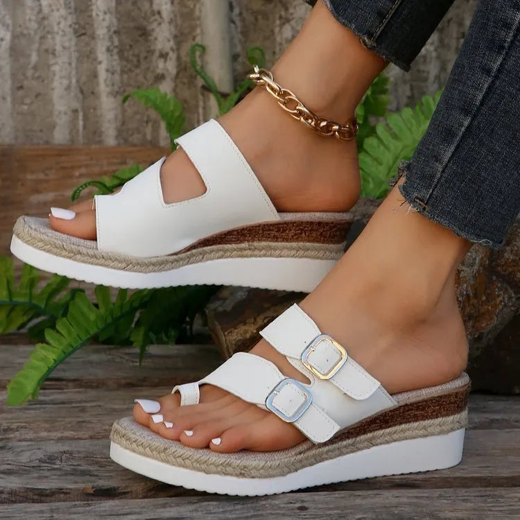 White patent leather wedge sandals with woven peep toe and finger fit design