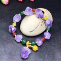 A natural style women's bracelet made with amethyst-shaped beads and a decorative fu character.