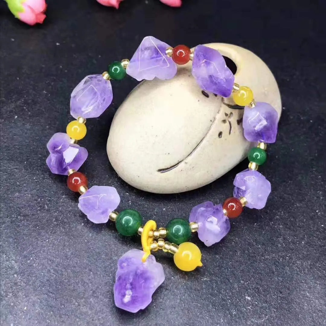 A natural style women's bracelet made with amethyst-shaped beads and a decorative fu character.