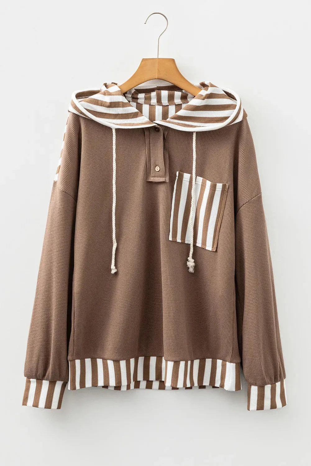 Straw yellow hoodie with waffle texture fabric and striped patchwork panels, featuring a drawstring hood and button neck.