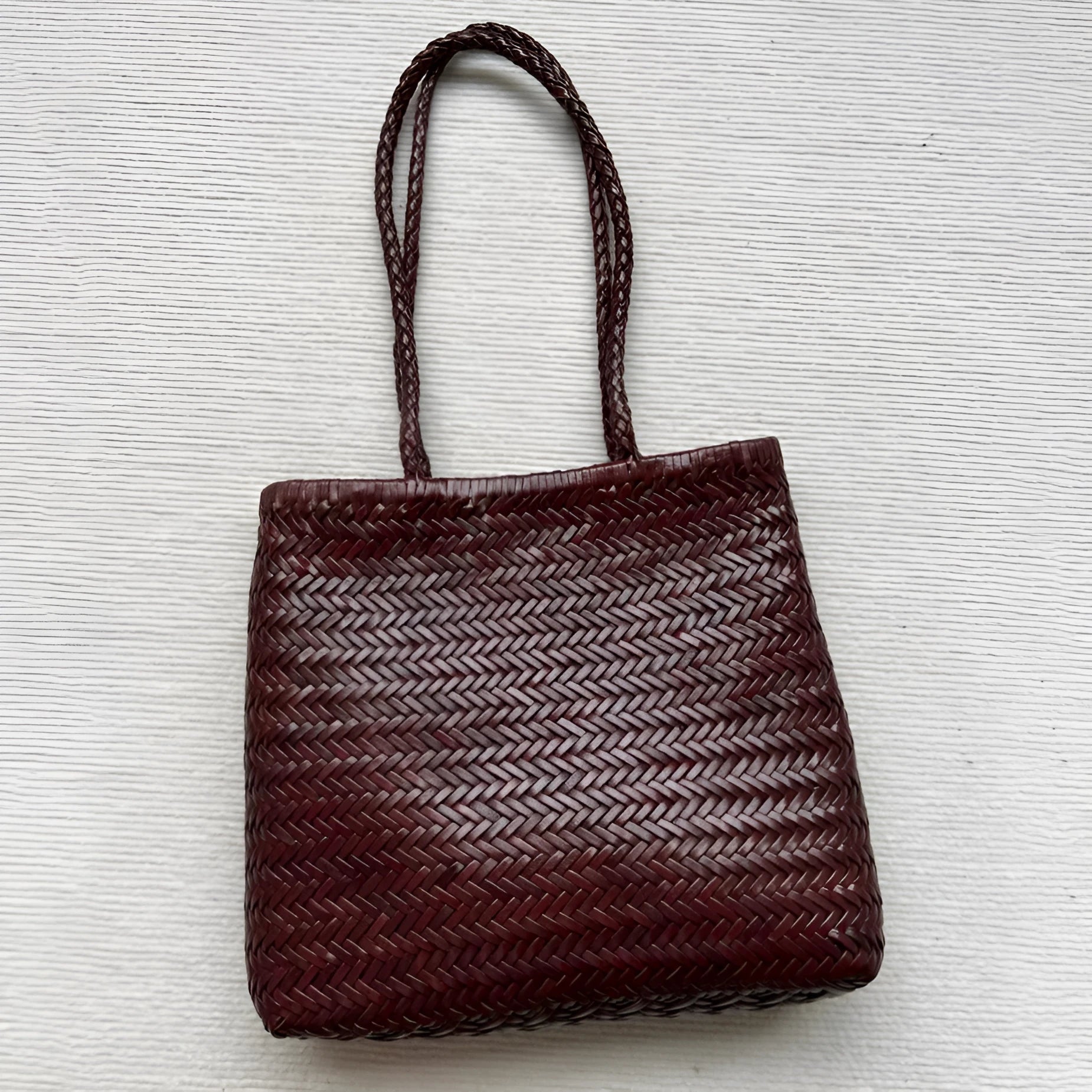 Brown woven leather tote bag with three-dimensional pockets measuring 27cm high by 30cm wide