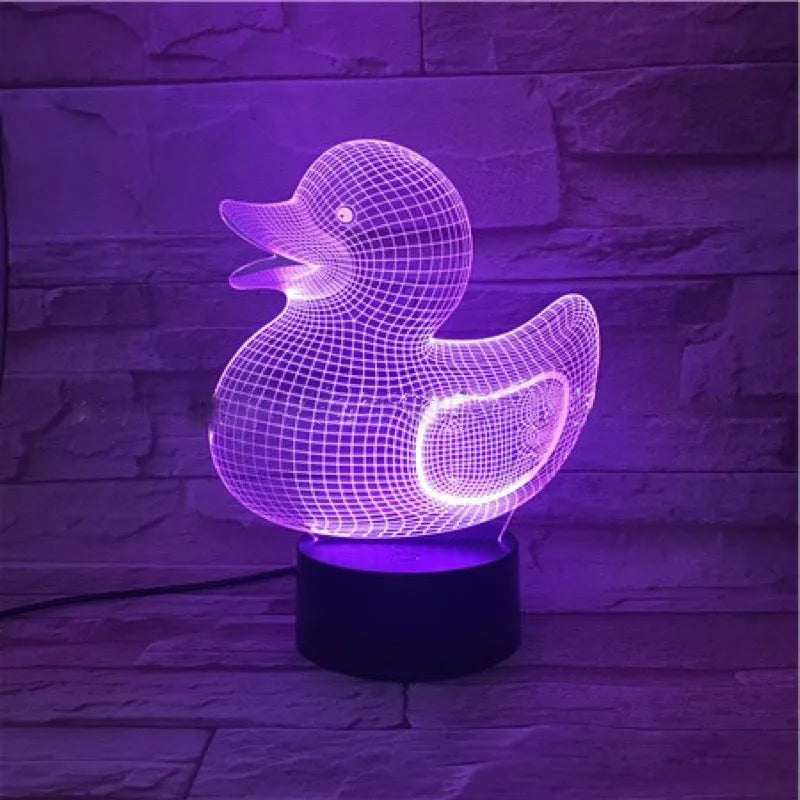3D little yellow duck night light with colourful LED illumination on a table