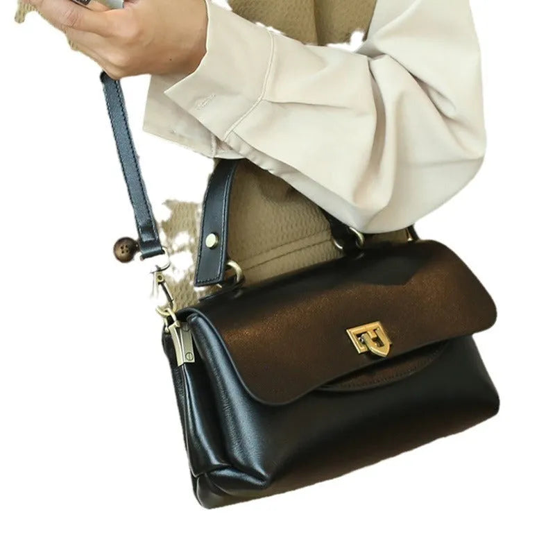 Women's dark brown genuine leather saddle back handbag with double shoulder straps showing internal organisation compartments