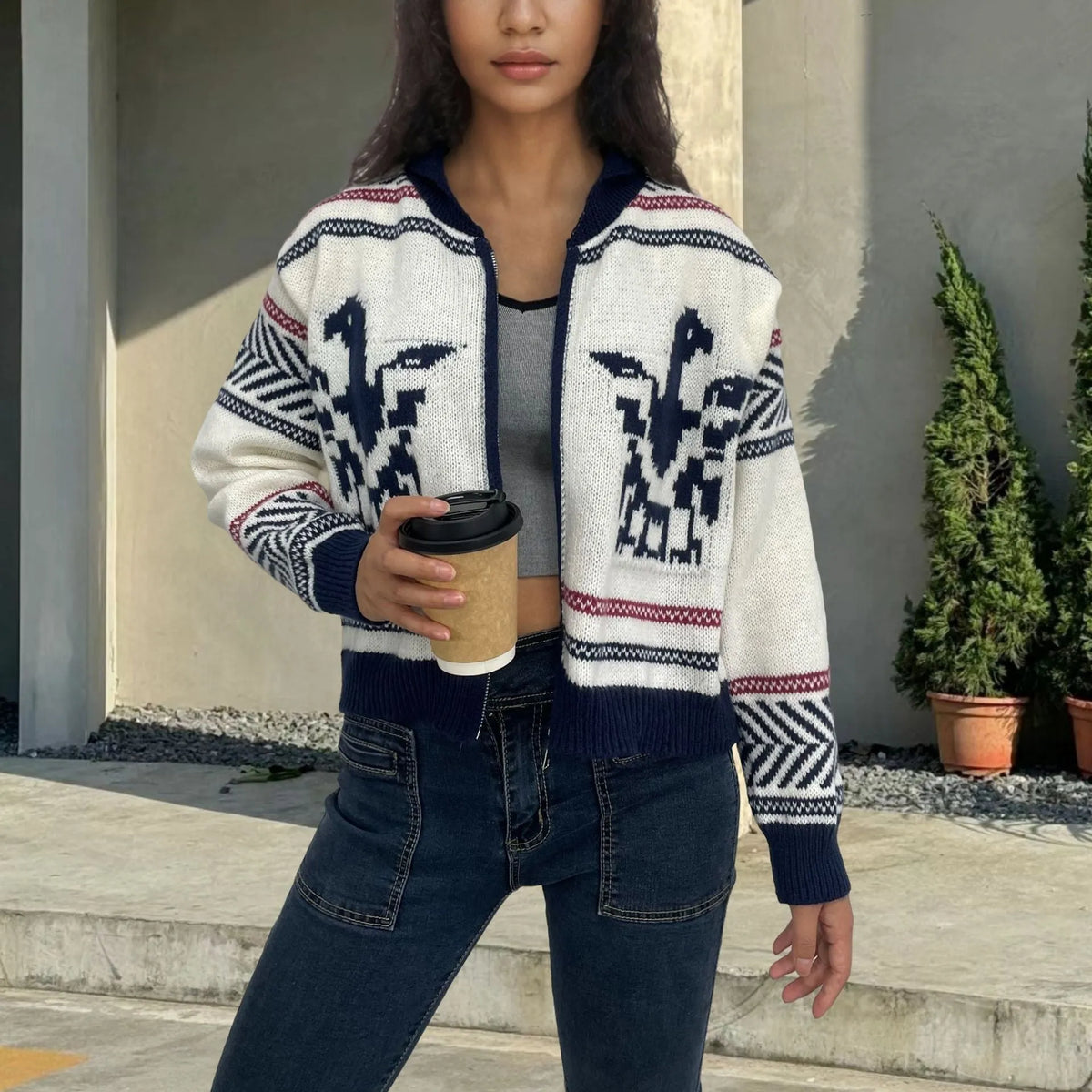 White women's zip cardigan with lapel collar and jacquard contrast colour stripes laid flat.