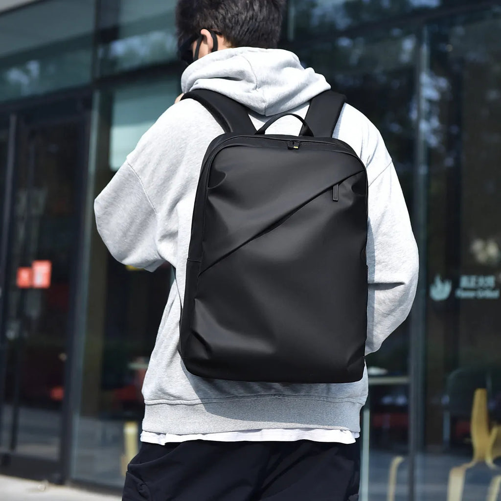 Waterproof large capacity PU backpack in black, blue, or grey with simple design
