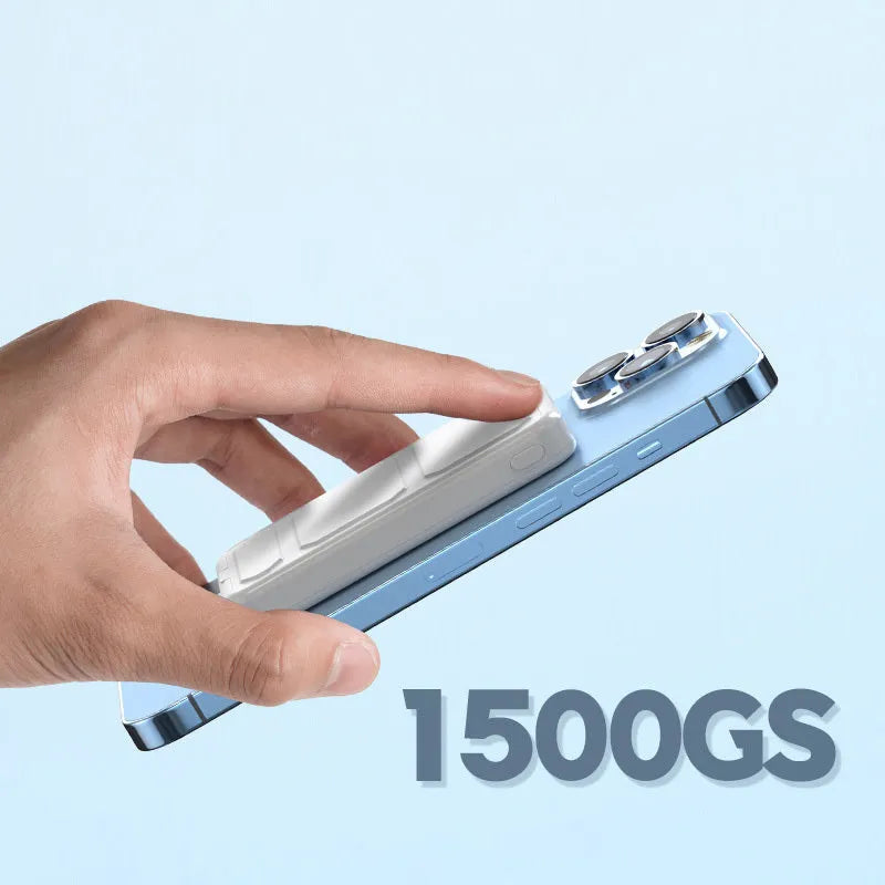 Silver magnetic wireless charging power bank with folding stand unfolded, shown next to a smartphone.