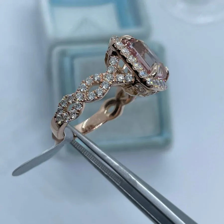 Geometric-shaped alloy ring with a rose gold electroplated finish on a neutral background.