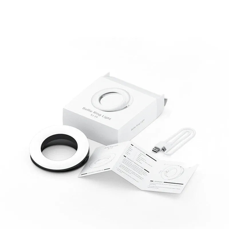 Compact black LED selfie ring light for mobile phones with USB cable.