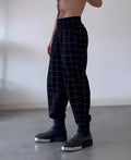 Men's plaid trousers with a removable apron bib featuring two large cargo pockets.