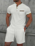 Men's grey zip-front polo collar short sleeve jacket and matching shorts set laid flat.