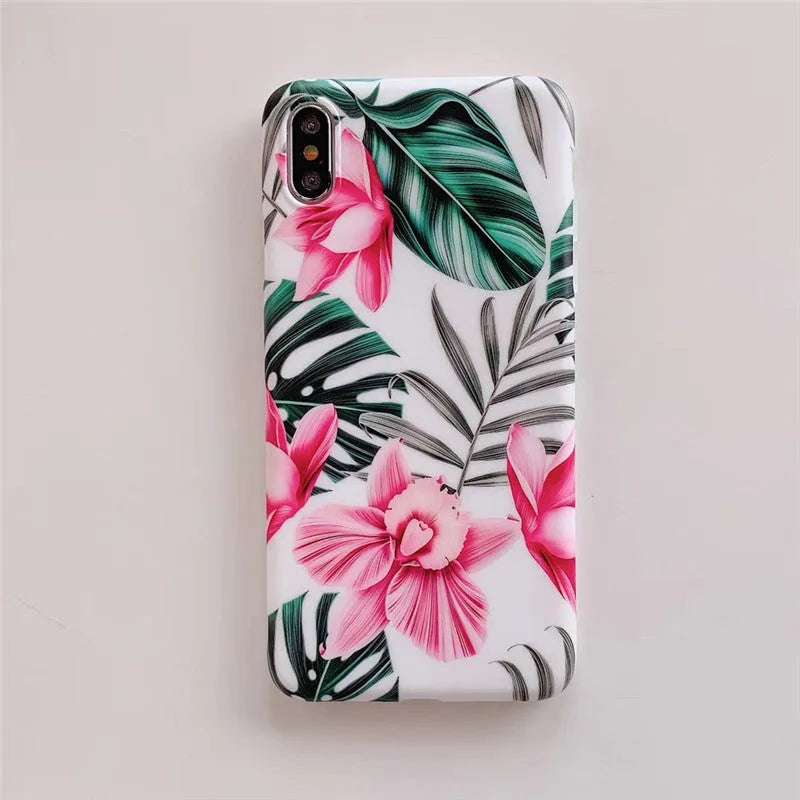 Pink floral pattern TPU back cover case for iPhone on a wooden table.