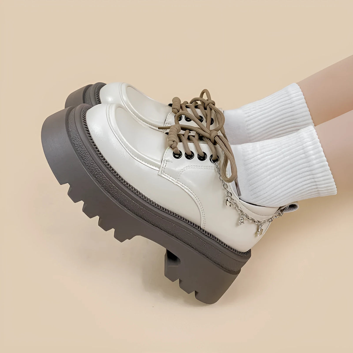 British style white platform leather Mary Jane shoes with chunky heel and lace-up front.