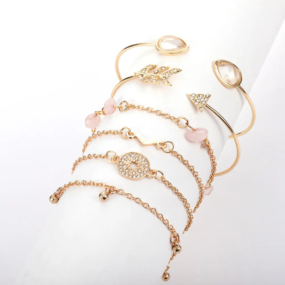 Gold tone six piece women's bracelet set with water droplet and arrow designs