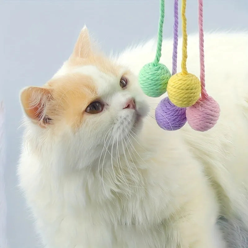 Colourful cat toy ball with attached rope and internal bell for interactive feline play