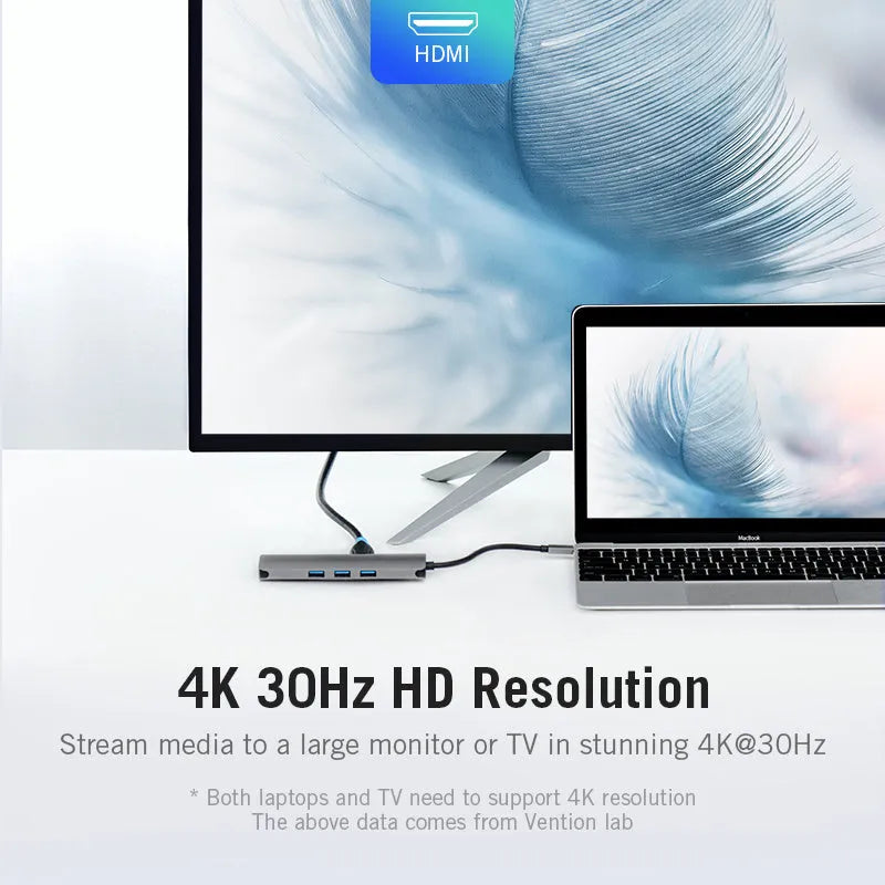 Deep grey Type-C to HDMI, USB 3.0, Ethernet, and card reader hub adapter on a desk