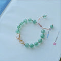 Handmade Hetian jade peach blossom strawberry quartz crystal bracelet for women showing strawberry quartz pearl and charm details