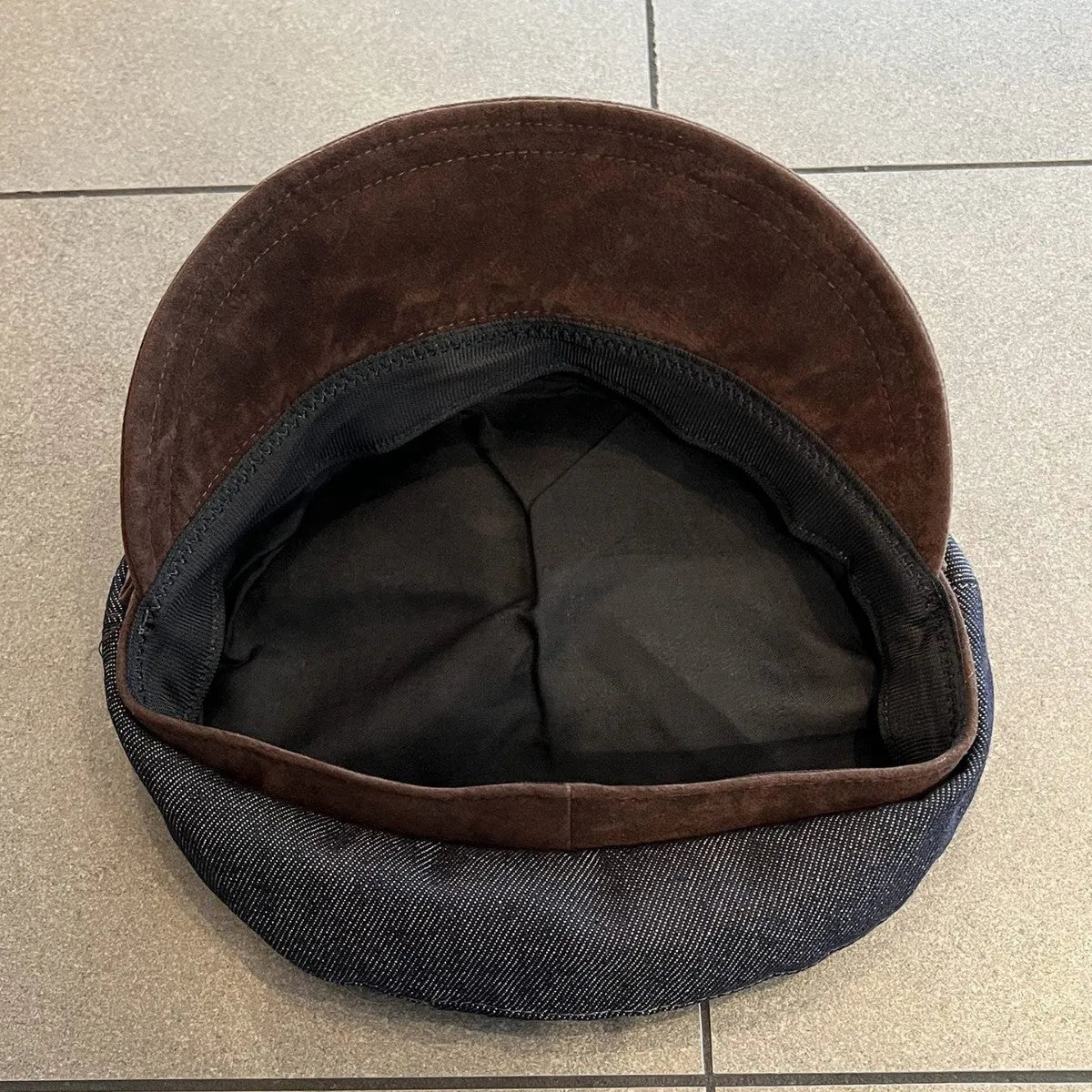 Dark blue denim newsboy hat with adjustable sizing and optional contrasting brim colours