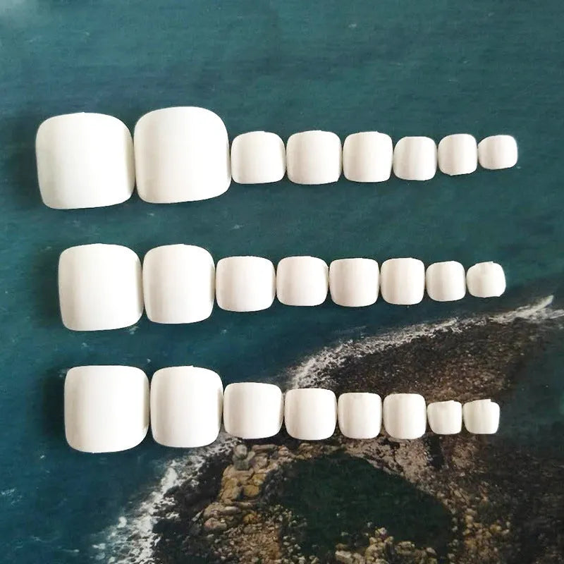 Set of white false nails with a starry sky pattern, includes glue for application.