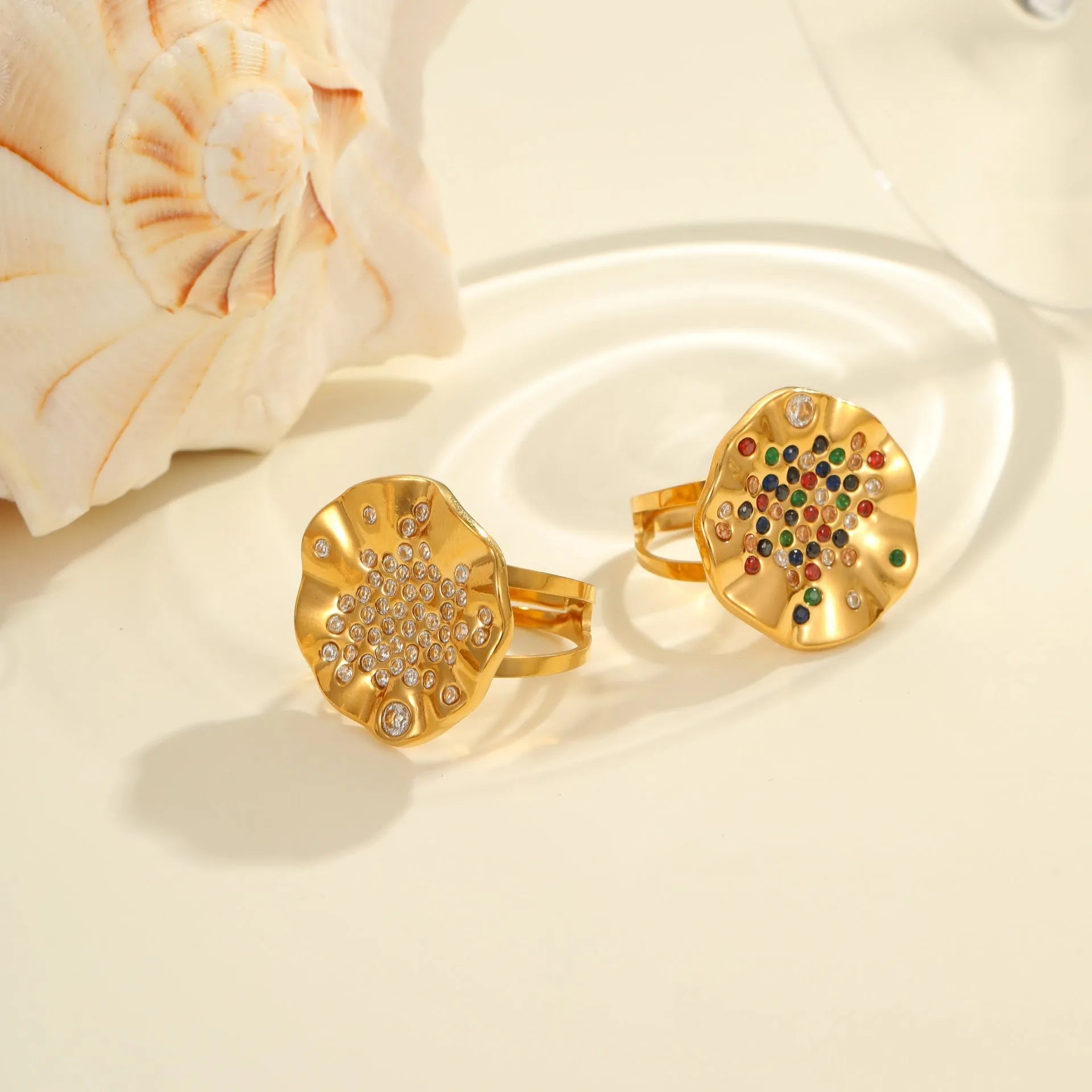 Adjustable open-mouth stainless steel ring with pleated geometric pattern and inlaid coloured crystal accents.