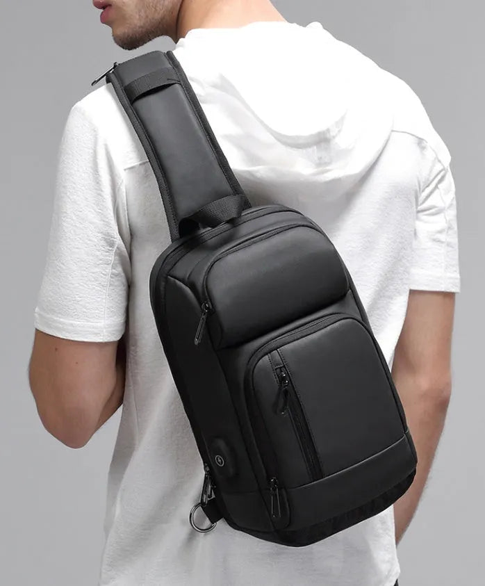 Black medium-sized PVC shoulder bag showing internal organisation pockets and air cushion strap