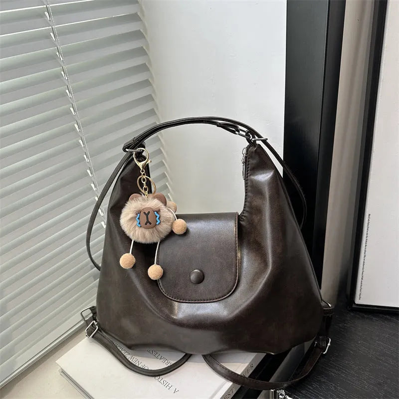 Brown textured PU one-shoulder bag with single strap showing internal phone compartment and horizontal organisation