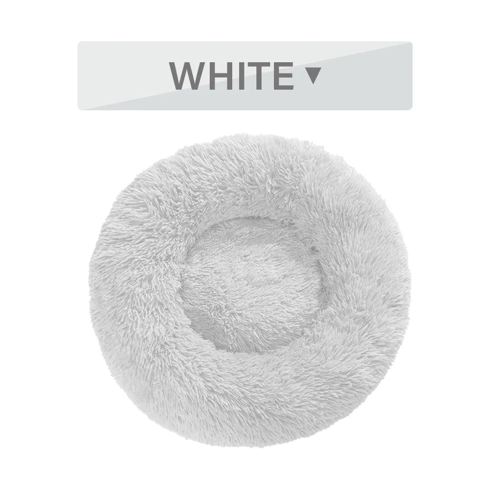 Fluffy donut-shaped dog bed in long plush fabric, showing raised rim and available colour options