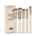 Five apricot-coloured angled makeup blush brushes with synthetic bristles arranged together
