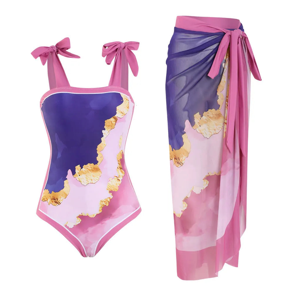 Floral print one-piece swimsuit with mesh tube top and detached skirt shown in brown.