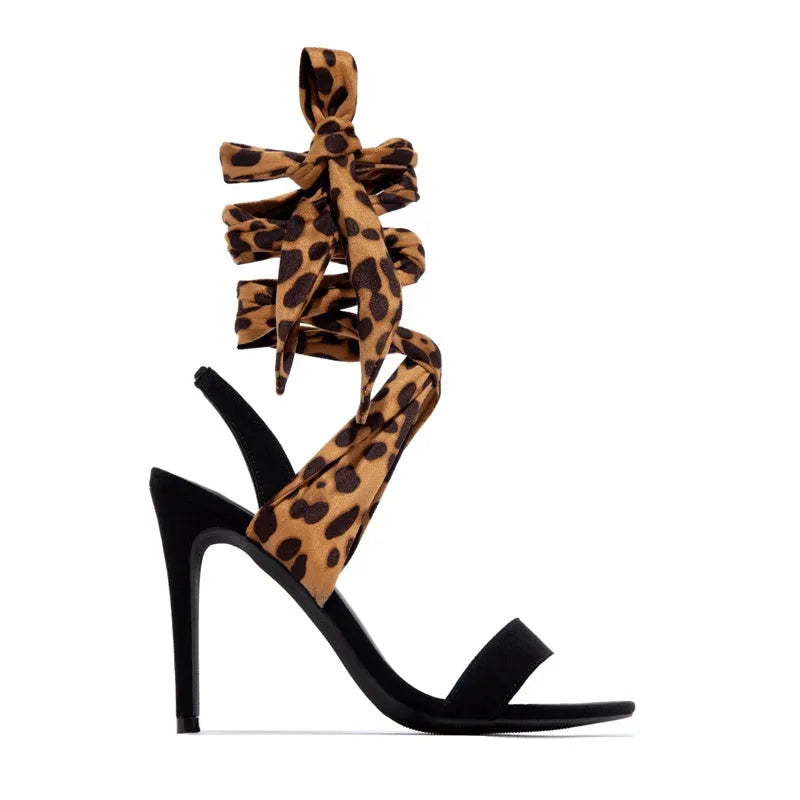 Light brown leopard print women's high heel sandals with criss-cross ankle straps and a pointed toe.