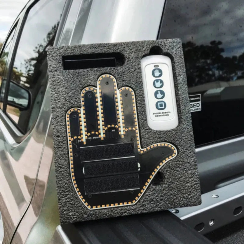 Black plastic LED gesture car light with remote control showing illuminated hand symbol.